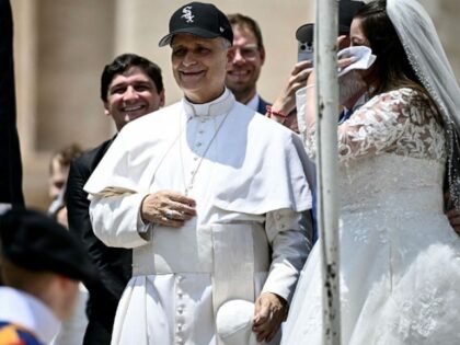 Pope Leo XIV (C) reacts wearing a Chicago White Sox baseball team cap as he meets newly we