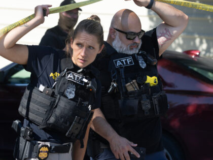 ATF agent investigate the scene where federal law enforcement agents reportedly shot a wom