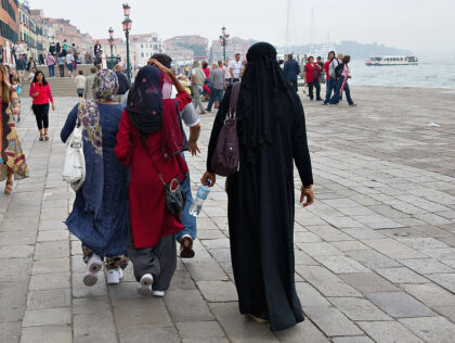 VENICE, ITALY - JUNE 01: Women wearing veils and burqua walks just few yards away of Flav