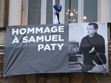 A portrait of French teacher Samuel Paty is displayed on the facade of the Opera Comedie i