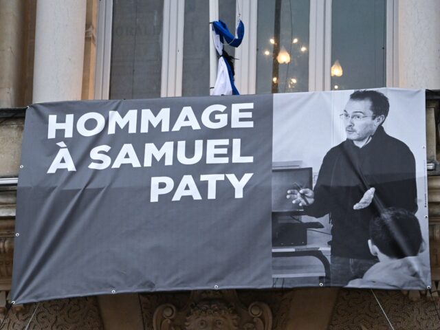 A portrait of French teacher Samuel Paty is displayed on the facade of the Opera Comedie i
