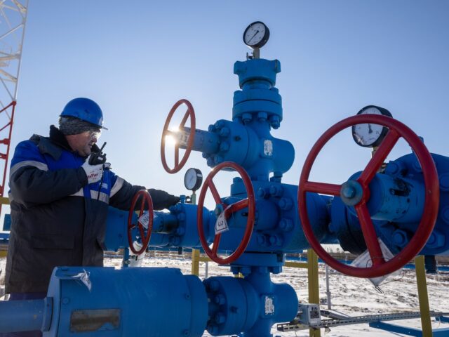 A worker turns a valve wheel at a gas well on the Gazprom PJSC Chayandinskoye oil, gas and