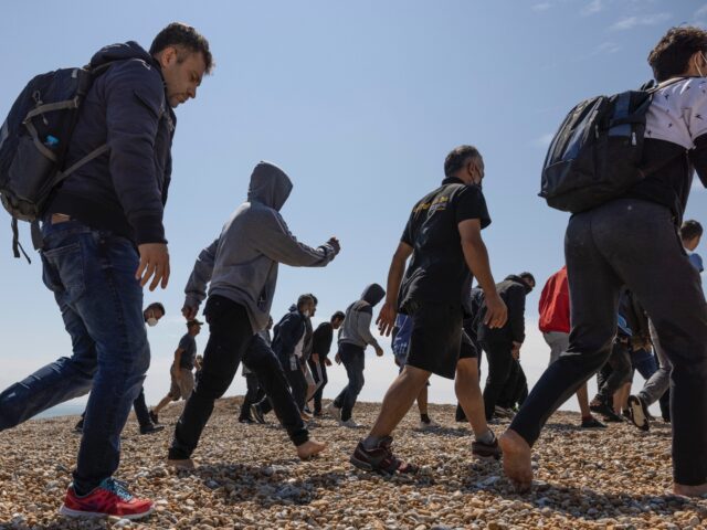 DUNGENESS, ENGLAND - AUGUST 04: A group of around 40 migrants arrive via the RNLI (Royal N