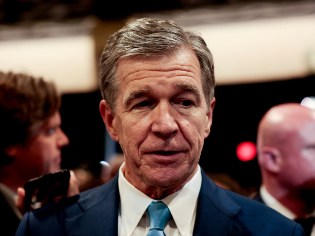 GettyImages-2170592168 Roy Cooper, governor of North Carolina, speaks to members of the media in the spin room fo