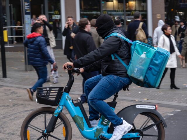Deliveroo takeaway delivery cycle courier with his identity concealed on 6th November 2024
