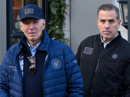 A November 29, 2024 photo shows US President Joe Biden and son Hunter Biden stepping out o