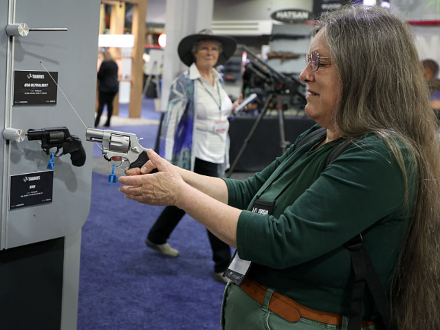 ATLANTA, GEORGIA - APRIL 26: Alice ruenenfelder looks at a Taurus handgun during the 2025