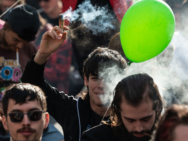 GettyImages-2213836983 MADRID, SPAIN - 2025/05/10: A man is seen smoking a large joint during the Global Marijuan