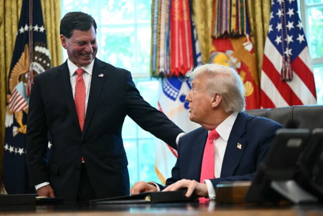 Commissioner of the Social Security Administration Frank Bisignano (L) looks on as US Pres