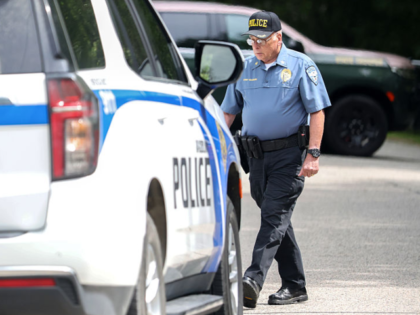 Madbury, NH - August 19: Madbury Police Chief Joseph McGann returns to his cruiser at the