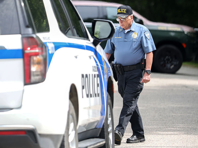 Madbury, NH - August 19: Madbury Police Chief Joseph McGann returns to his cruiser at the
