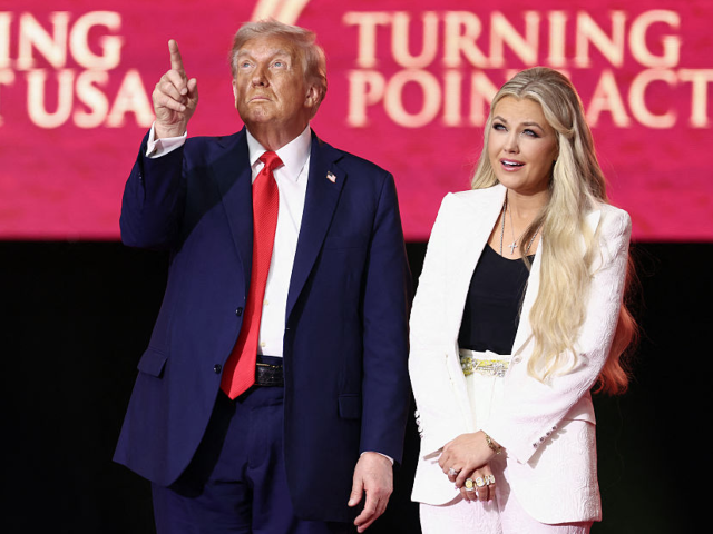 US President Donald Trump reacts next to Erika Kirk, widow of Charlie Kirk, after speaking