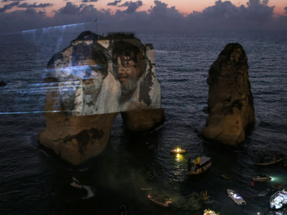 TOPSHOT - The portraits of slain Hezbollah leaders Hassan Nasrallah (R) and Hashem Safiedd