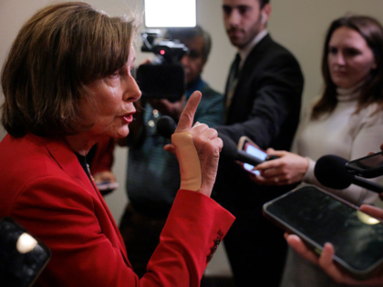 WASHINGTON, DC - OCTOBER 01: Rep. Nancy Pelosi (D-CA) talks to reporters in the hallway ou