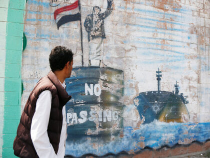 SANA'A, YEMEN - OCTOBER 1: A Yemeni man looks at artworks depicting the Yemen's