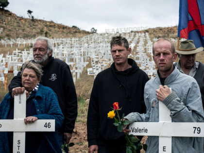POLOKWANE, SOUTH AFRICA - OCTOBER 4: Relatives of killed farmers stand with crosses during
