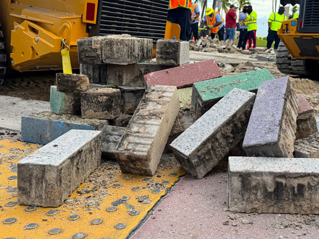GettyImages-2239214299 Workers remove part of the rainbow sidewalk at the intersection of Ocean Drive and 12th St
