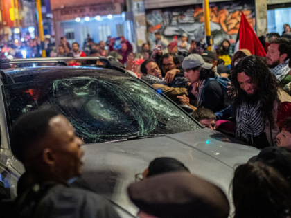 BOGOTA, COLOMBIA - OCTOBER 7: A car runs over demonstrators during a pro-Palestinian prote