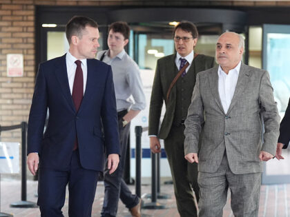 Shadow justice secretary Robert Jenrick (left) walks with Hamit Coskun (front right)outsid