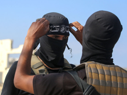 TOPSHOT - A Palestinian militant fighter of the Ezzedine al-Qassam Brigades, the armed win