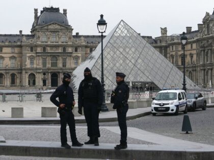 French police officers stand in front of the Louvre Museum after robbery, in Paris on Octo