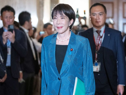 Japan's ruling Liberal Democratic Party (LDP) President Sanae Takaichi (C) walks before si