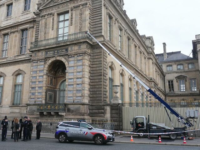 FRANCE-MUSEUM-ROBBERY French police officers stand next to a furniture elevator used by robbers to enter the Lou