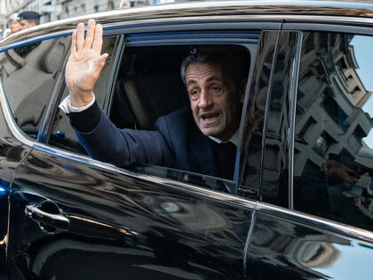 France's former president Nicolas Sarkozy waves to his supporters as he leaves his re