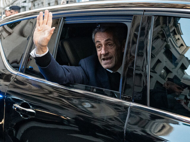 France's former president Nicolas Sarkozy waves to his supporters as he leaves his re