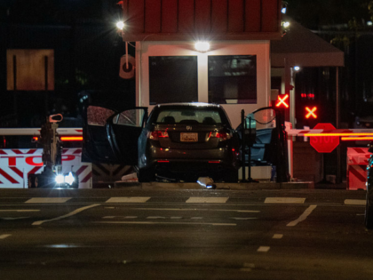WASHINGTON, DC - OCTOBER 21: A bomb detection robot inspects a vehicle that rammed a secur