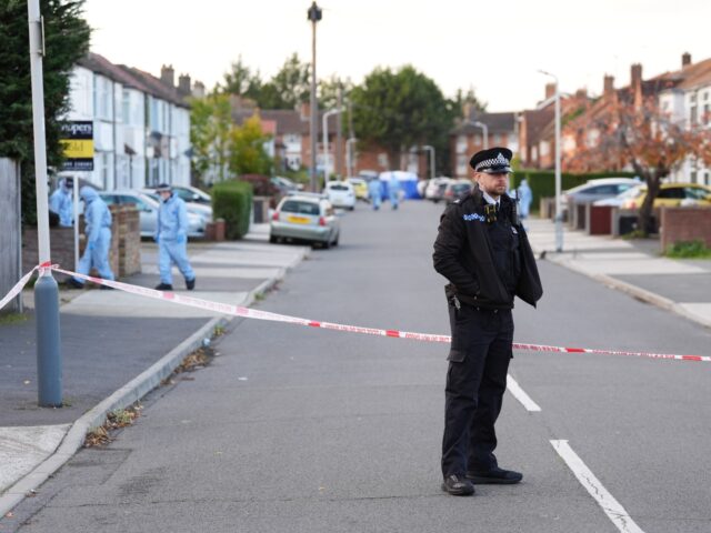Police officers in Midhurst Gardens in Uxbridge, west London, after a man was stabbed to d