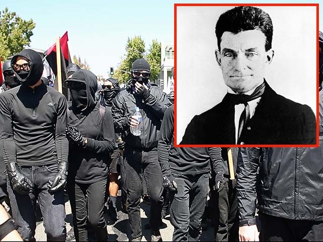 GettyImages1070673620 Black-clad Antifa marchers arrive at Civic Center Park, Sunday, Aug. 27, 2017, in a counte