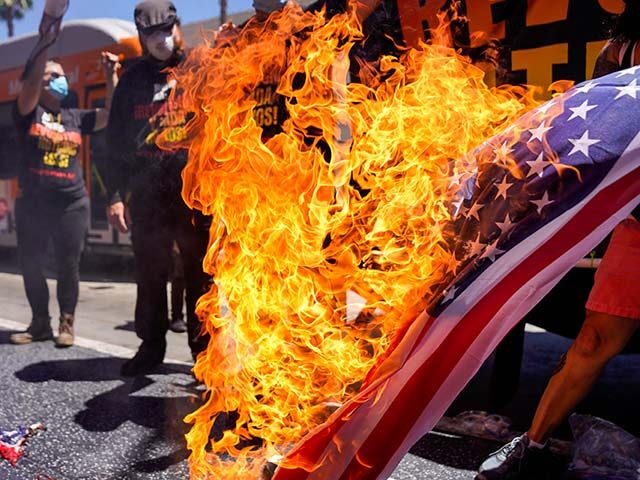 Protesters set fire to an American flag near President Donald Trumps Star on the Hollywood