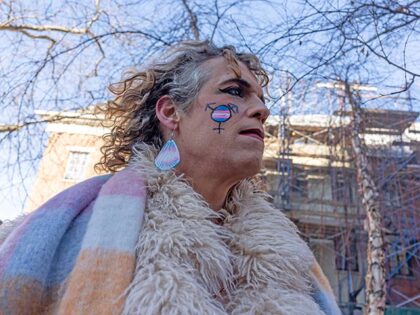 Members of the LBGTQ+ community and allies protest the removal of the word transgender fro