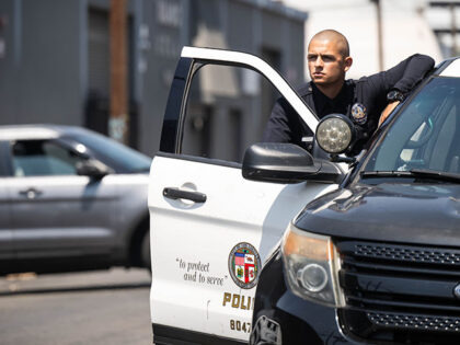 An LAPD officer is on scene of a shooting where two people were killed and six others were