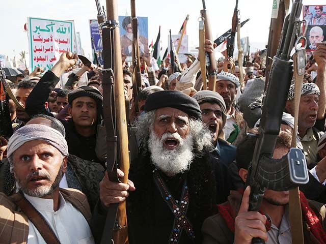 GettyImages2241683401 Protesters brandish weapons, flags of Yemen and Palestine, and anti-US and Israel emblems
