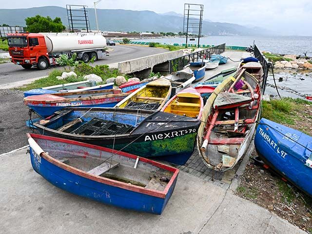 Fishermen boats are tied together in preparation for the arrival of Hurricane Melissa near