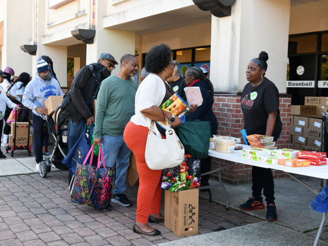 Federal employees and contractors receive food items during a free food distribution in Hy