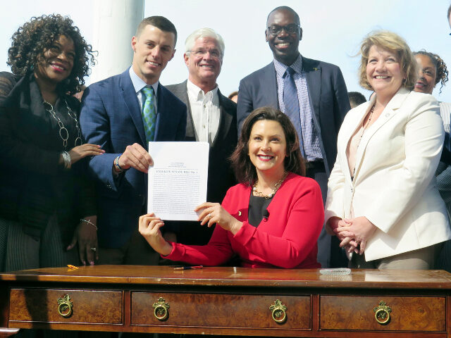 In this May 30, 2019, file photo, Michigan Gov. Gretchen Whitmer, seated, displays the aut