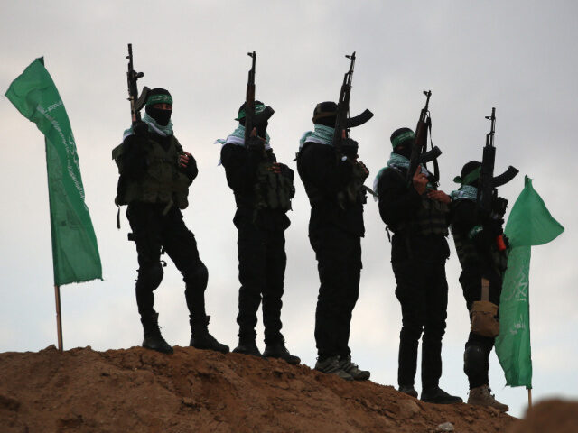 Hamas Fighters Releasing Hostages Palestinian Hamas militants gather at the site of the handing over of the bodies of four I