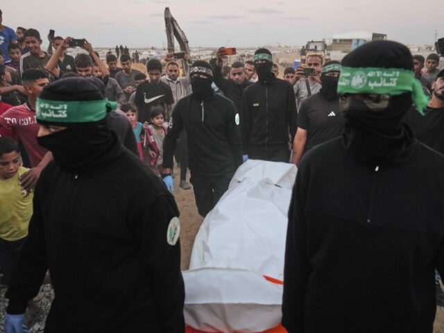 Hamas body (Jehad Alshrafi / Associated Press) Hamas militants carry a white bag believed to contain a body, after retrieving it from a t
