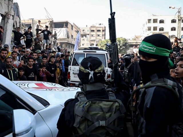 GAZA CITY, GAZA - OCTOBER 13: Hamas members hand over some of the 20 Israeli hostages to I
