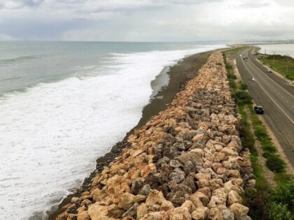 This aerial view shows storm surge crashing into the seawall that protects Palisadoes Stri