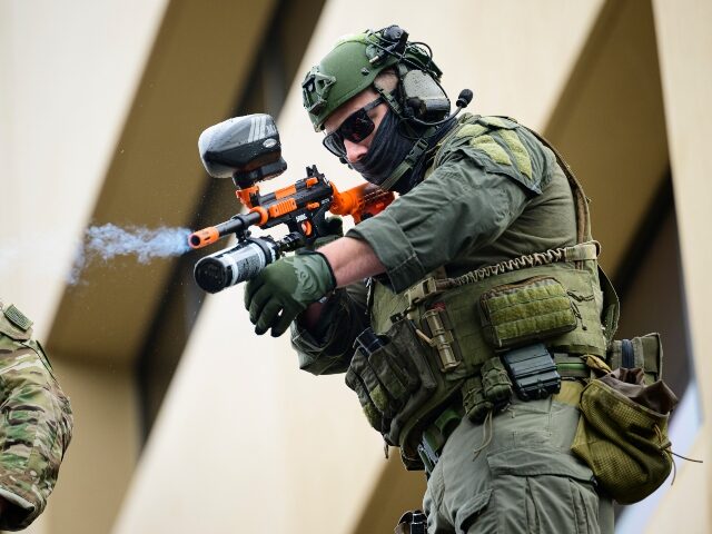 ICE agent firing pepper balls