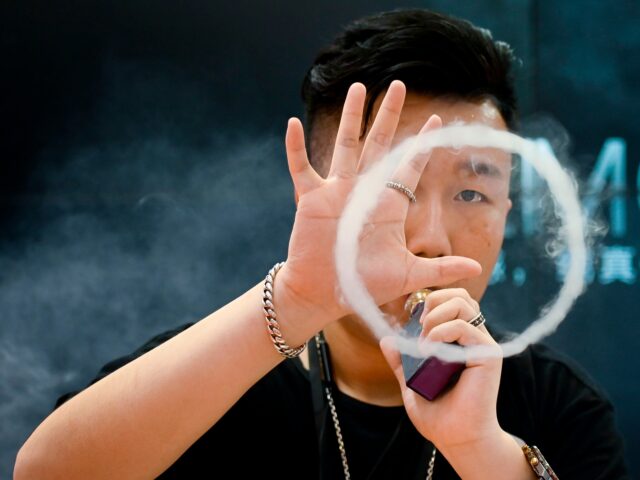 Illegal Chinese Vapes A promoter of a e-cigarette company smokes an electronic cigarette at the Beijing Internat