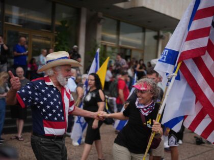 People dance as they celebrate following the announcement that Israel and Hamas have agree