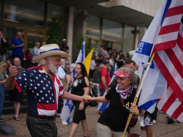 People dance as they celebrate following the announcement that Israel and Hamas have agree