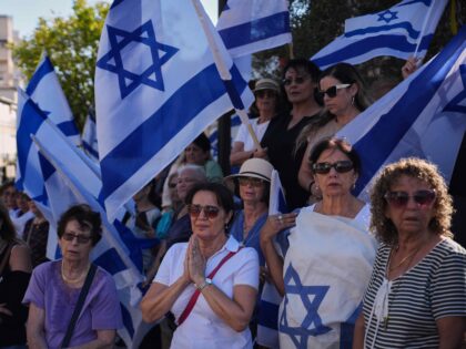 Mourners gather near the car carrying the coffin of slain hostage Guy Illouz during his fu