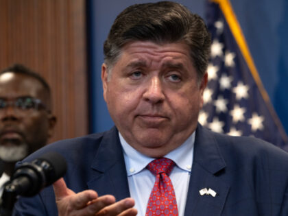 Chicago Mayor Brandon Johnson (L) listens as Illinois Governor JB Pritzker speaks to the p