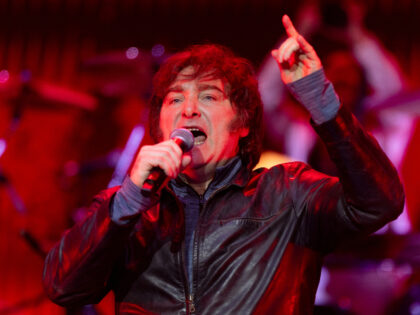 Argentine President Javier Milei sings in a show with a band during the presentation of hi